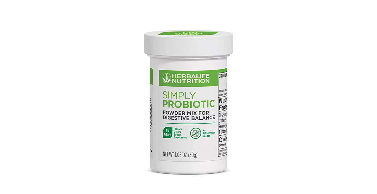Herbalife Simply Probiotic packaging on a wooden table beside a glass of water